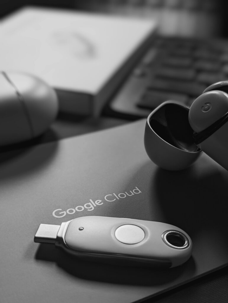 Black and white tech scene featuring a USB device and Google Cloud logo, embodying digital connectivity.